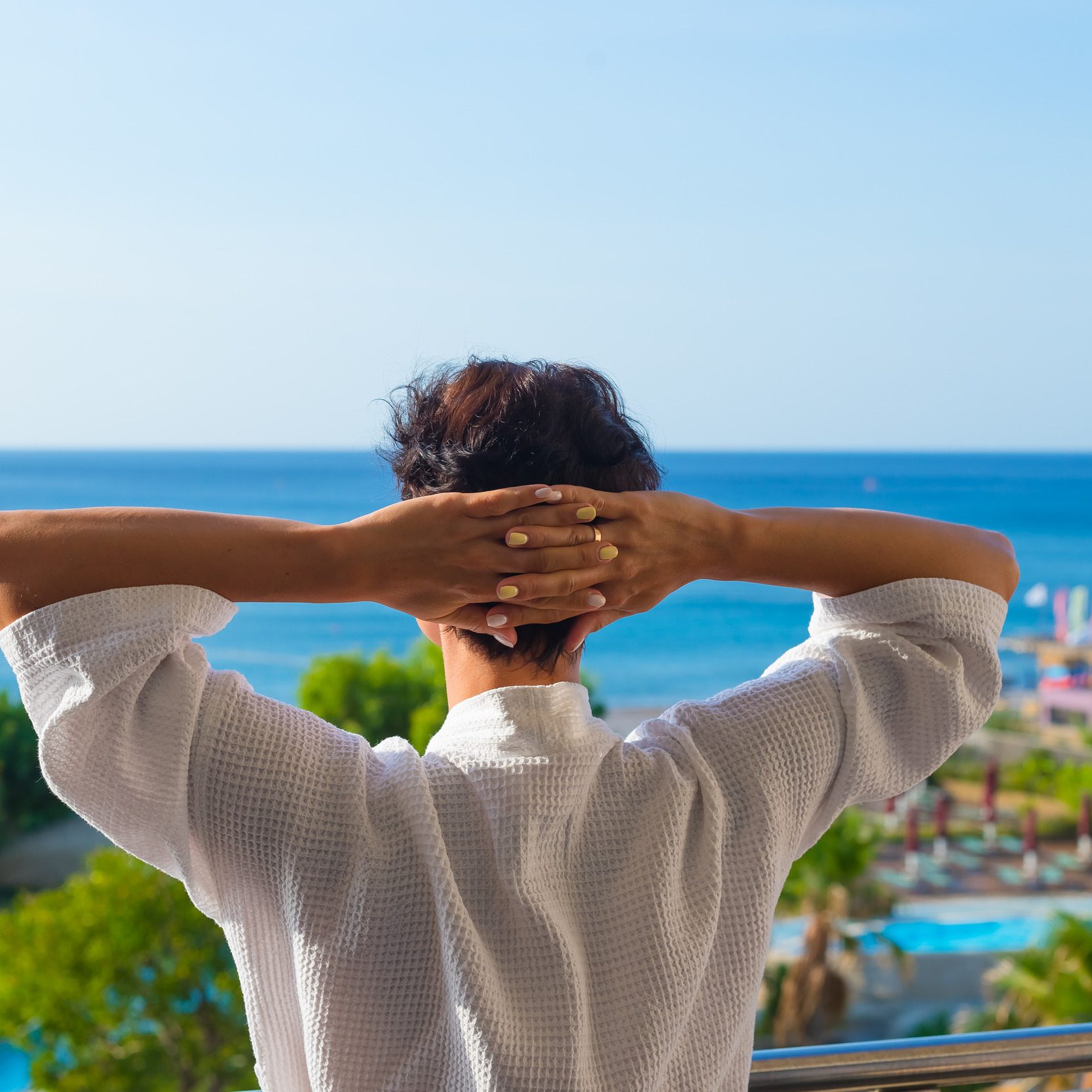 view-from-back-woman-standing-balcony-summer-morning (1)